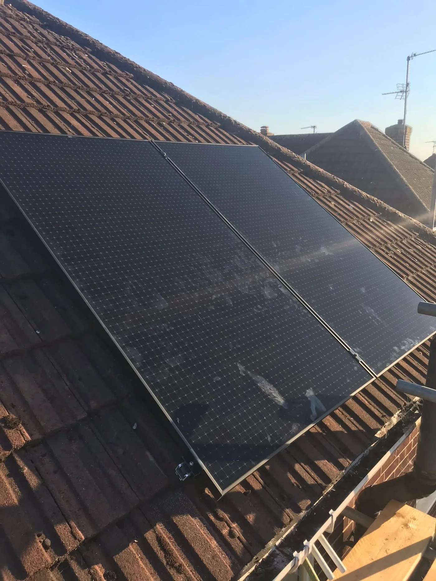 Close-up of solar panels installed on a tiled roof in Cornwall
